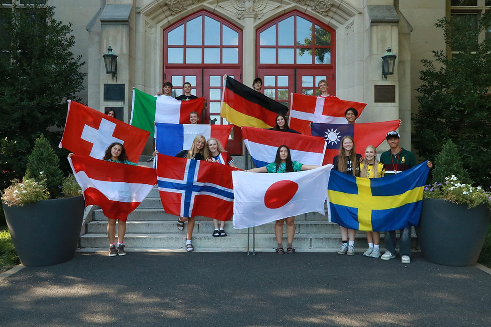 Holding up our flags after revealing our nationality at the talent show