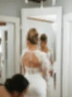 Bridal alterations Draper Utah and Salt Lake City Utah bride in front of mirror during wedding dress fitting with seamstress providing personalized gown adjustments at CleanMeNow