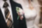 Men’s suit alterations Draper Utah and Salt Lake City Utah close up of dark wedding suit jacket with tie and boutonniere showing groom formalwear tailoring at CleanMeNow