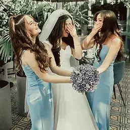 Bridal party alterations happy bride in wedding dress laughing with bridesmaids after fittings at CleanMeNow alterations and dry cleaning in Draper Utah and Salt Lake City, Utah