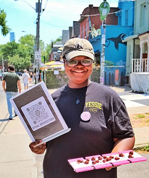 Trin holding menu and brownie samples.