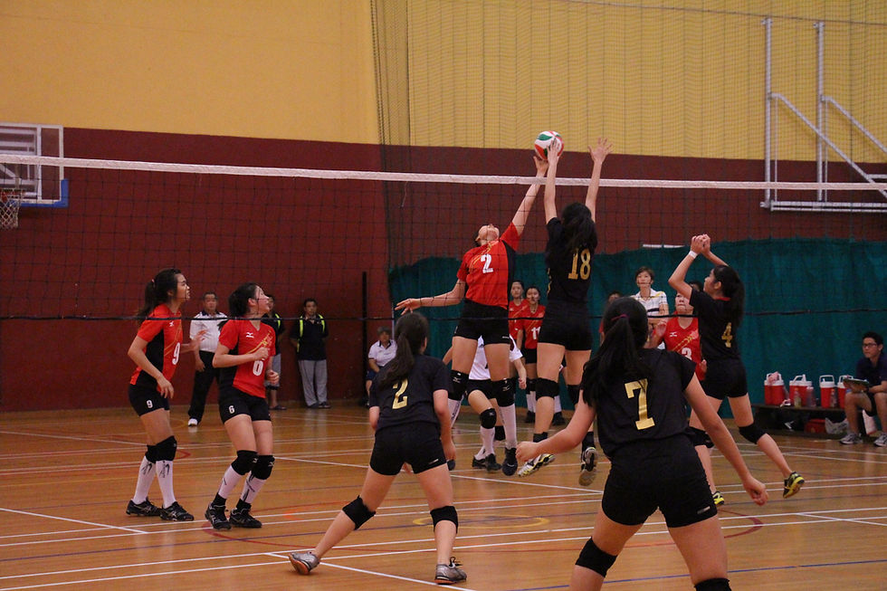 The stand-off between Hwa Chong Junior College’s Center Player No. 2 and Victoria Junior College’s Center Blocker No. 18. HCJC Center Player sends a spike across, only to be met with her rivalry who jumped and made an attempt to block off the attack. (Photo credit: Goh Shu Hui Gina)