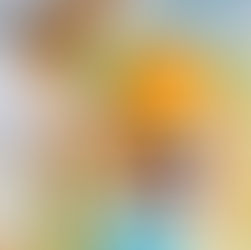 Hands holding paintbrushes in front of a watercolor set.