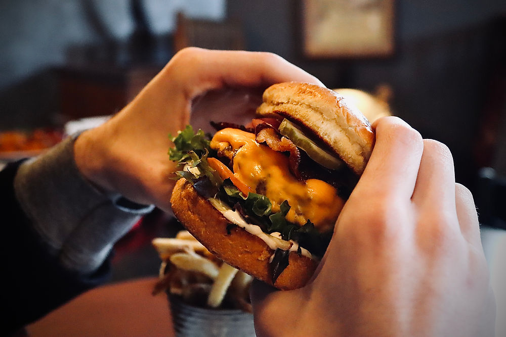 Handheld gourmet cheeseburger served at The Red Stag Restaurant in Wytheville VA