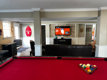 Pool table in game room for added fun. Open to enjoy family movies & games. Multi-game video console. Full refrigerator & microwave.