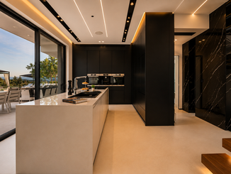 Luxury open-plan kitchen opening to the outdoor dining terrace at The One Villa Crete