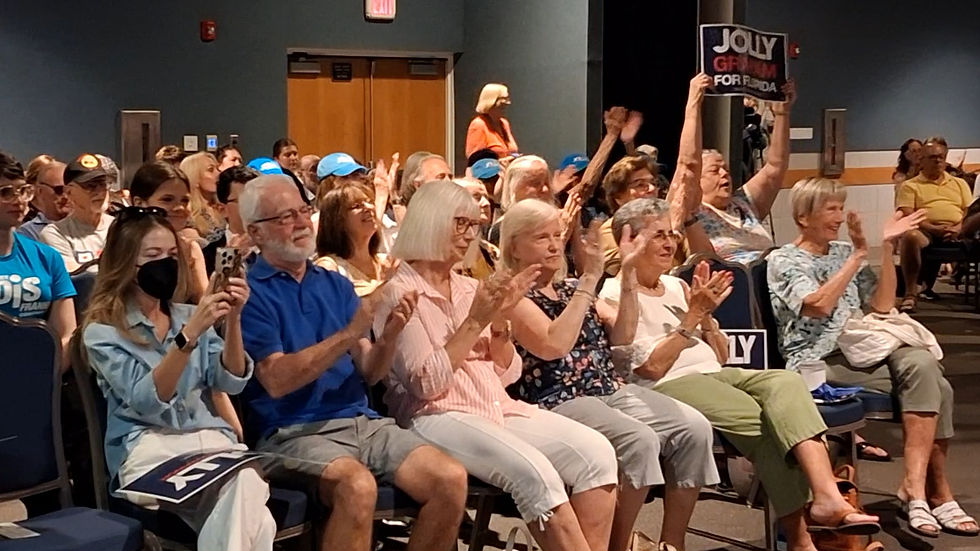 Attendees clap for David Jolly, at a Boca Raton forum in July 2026.
