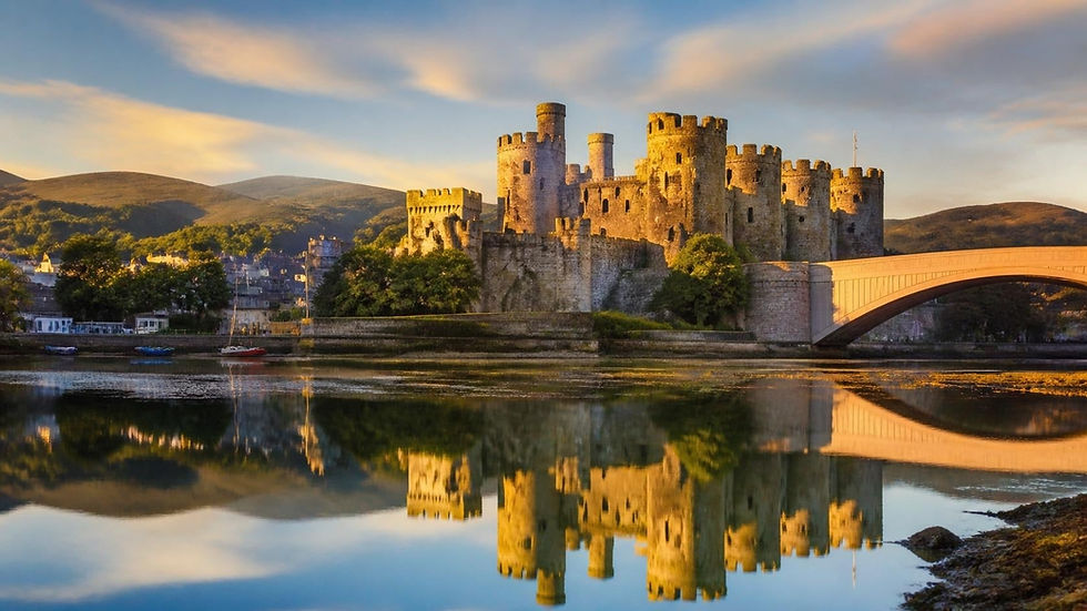 Conwy Castle reflected in the estuary at golden hour