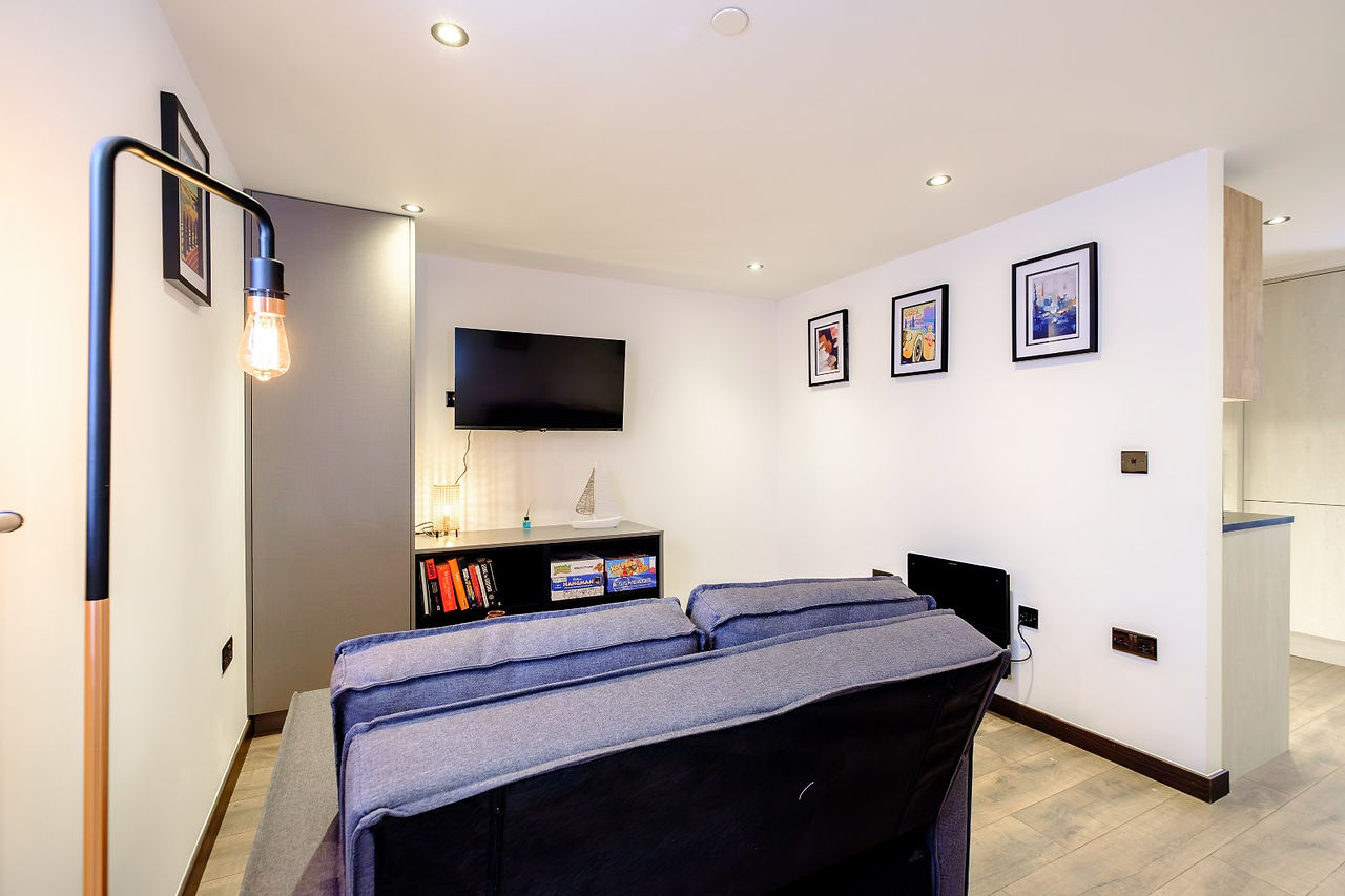 Cosy cottage living room with TV and sofa
