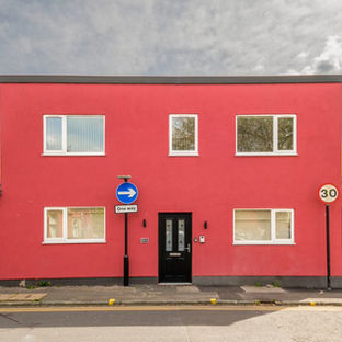 Red building, black door, 30 speed limit sign