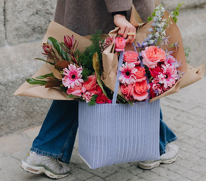 Person mit zwei Blumensträuße