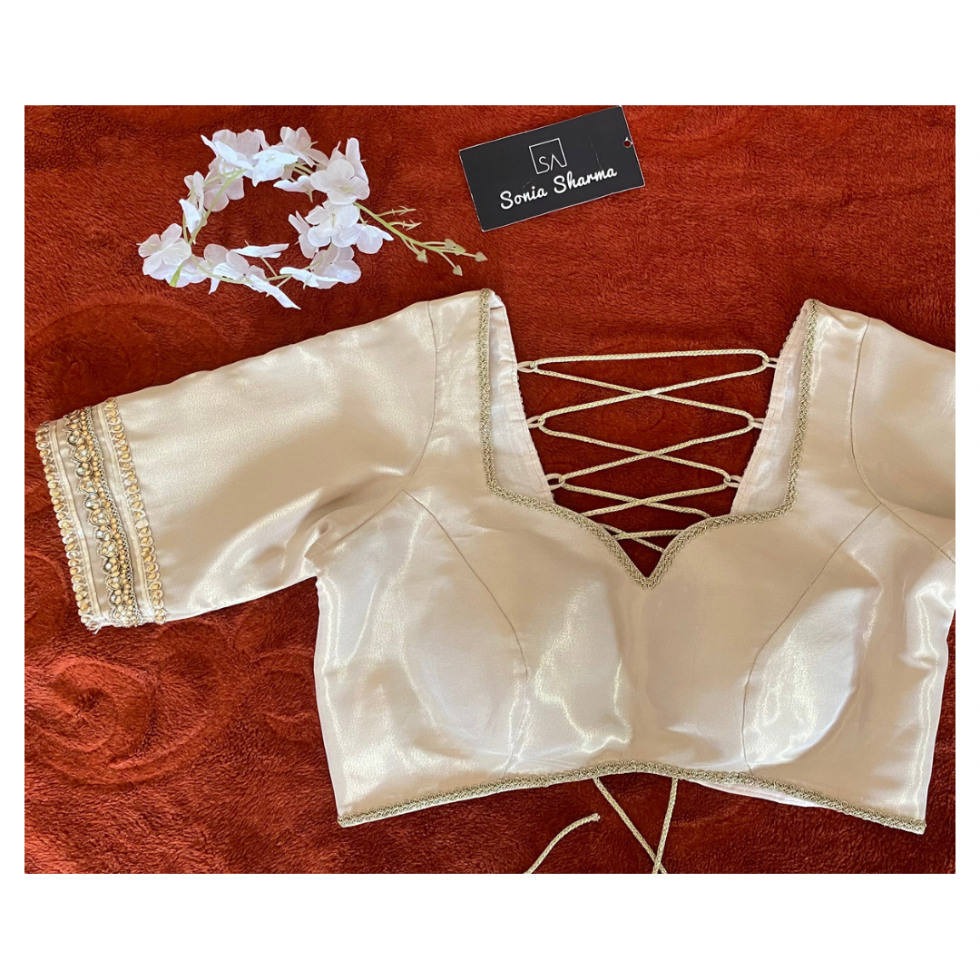 Gold zari white backless blouse.