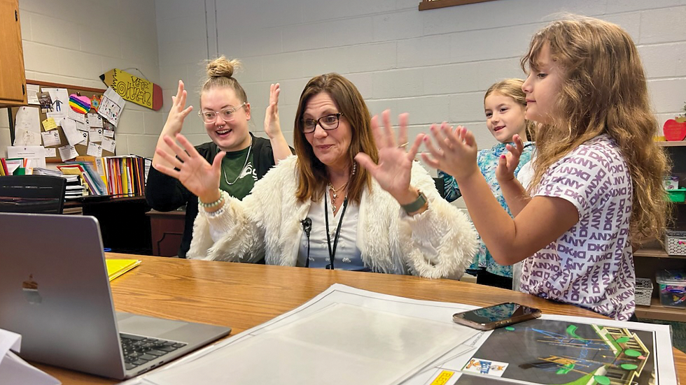 Silent applause from a group of children and adults