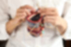 close up of woman hands knitting with knitting needles.jpg