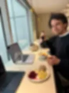 TechNovice author Nico Dudli testing the Saily Ultra eSIM free lounge perk, enjoying Swiss food and working on a laptop at the Aspire Lounge in Zurich Airport.