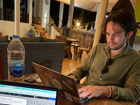 Remote work from Koh Kood, Thailand – Nico Dudli working on his laptop with a secure connection while traveling.