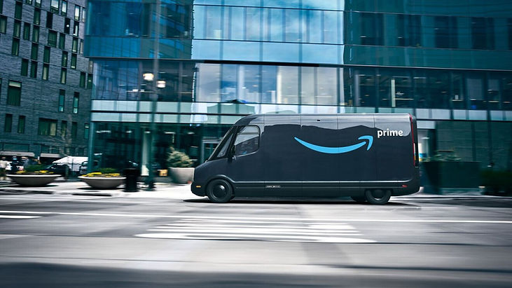 Amazon Rivian electric delivery van on city street, part of Amazon's 50,000-strong electric fleet working toward 100,000 vans by 2030. Image: Amazon / aboutamazon.com