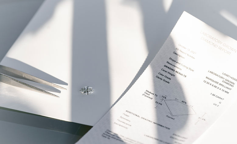 a loose marquise diamond ring next to the diamond certification