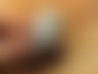 Hand holding a brown coin purse with a folded one-dollar bill inside, set on a wooden surface.