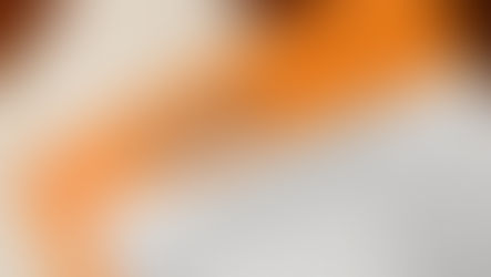 NDA document on orange surface with wooden letter tiles spelling "NDA." The document features standard agreement text and company details.