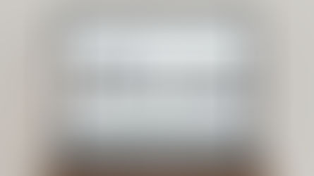 Laptop with blurred screen and text "NOTARY SERVICE DEPARTMENT" overlay. Black and white logo of pen nib. Simple, professional setting.