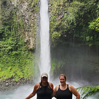 My sister and I standing in front of La Fortuna Waterfall in Costa Rica