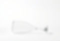a single empty long stemmed wine glass laying on it's side at the bottom of the page with