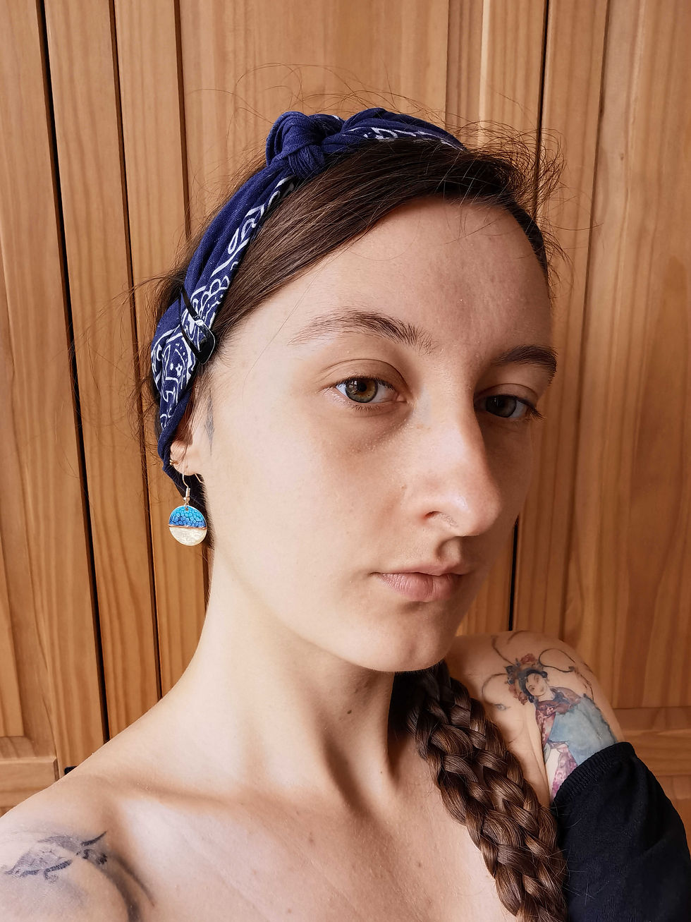 Thumbnail: Blue handmade earrings being worn in portrait. art jewellery