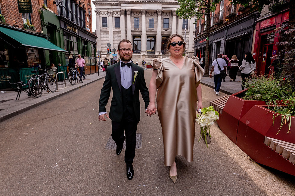 Síona and James walking through Dublin city centre after their wedding