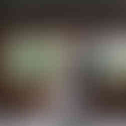 wedding couple cuddling inside barn during photoshoot looking out window