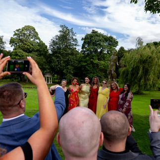 photo of someone takin a photo of a group of girls