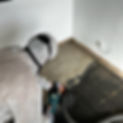 Worker stripping back floor
