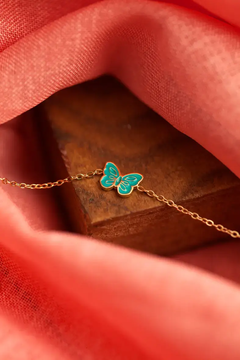 bracelet ajustable pour enfant en acier inoxydable doré avec un papillon bleu turquoise