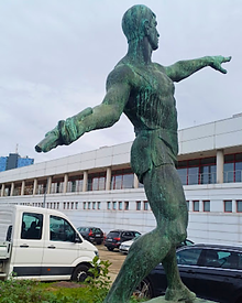 Vintage statue of a discus thrower at Dinamo Stadium athletic field in Bucharest.