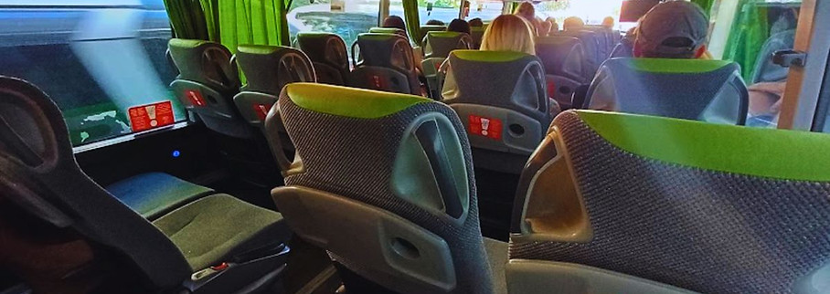Interior seating of FlixBus during daytime ride with rows of seats and natural light
