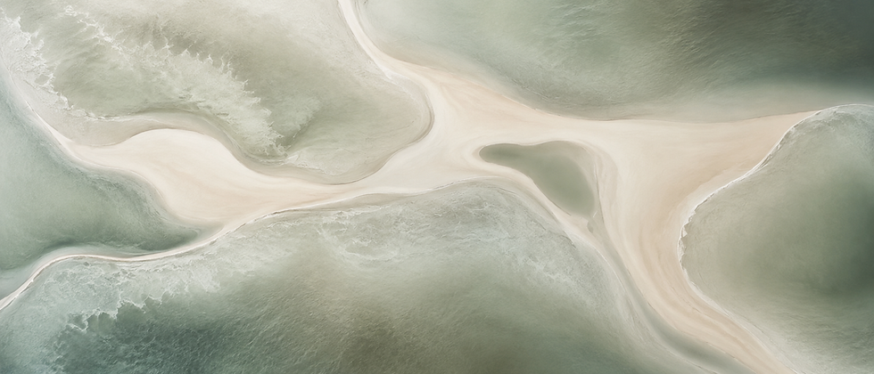 Abstract aerial view of sand dunes and luxury architecture.