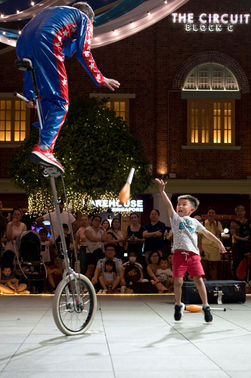 A young boy and a street performer.
