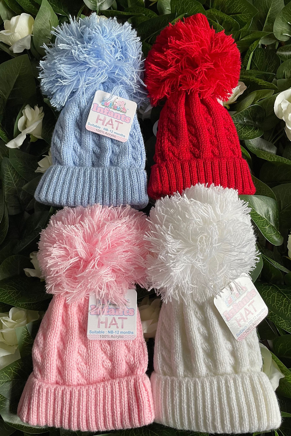 Knitted pompom hats in various colours, for babies age newborn up to 12 months.