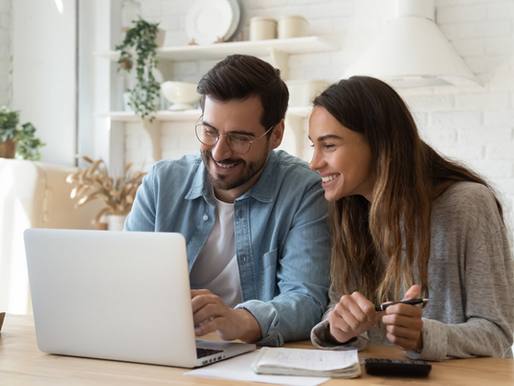 Two People Looking at a Laptop