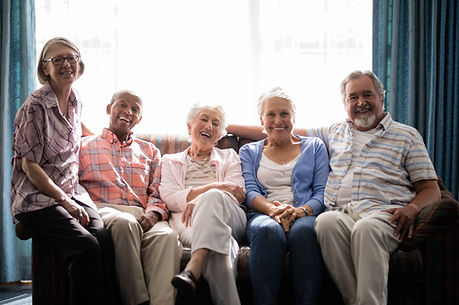 Smiling senior people sitting on couch