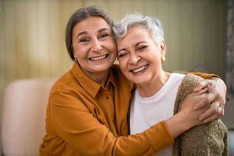 2 ladies hugging each other
