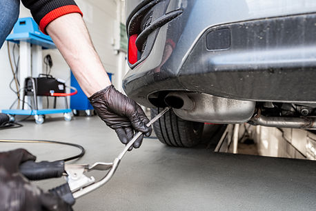 An image of a car receiving inspection and emission service