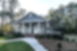 A house with vinyl siding surrounded by trees