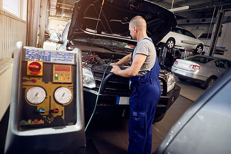 A mechanic is servicing a car's cooling and heating system