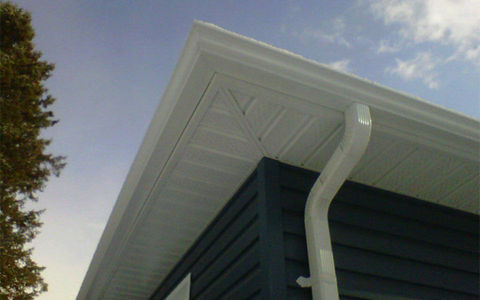 Photograph taken from a lower surface showing a white coloured roof and a drain pipe.