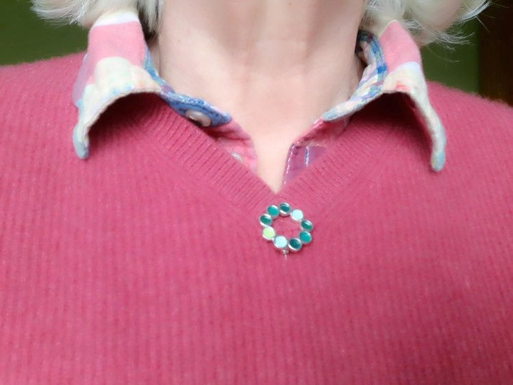 Thumbnail: Enamelled silver Encircled brooch in various opaque green enamels on model