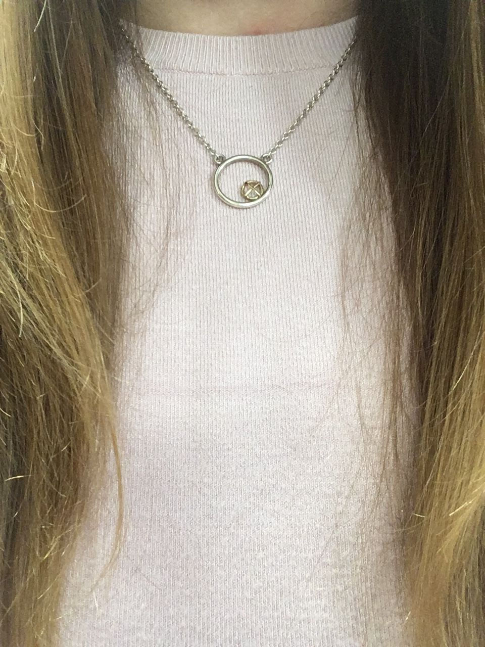 Thumbnail: Encircled pendant gold Kiss Hug on silver on model