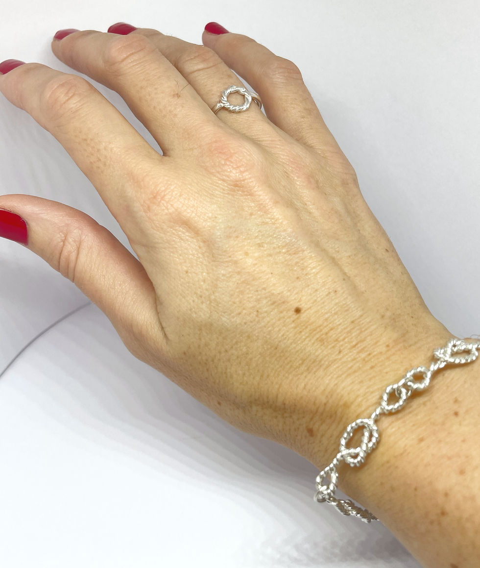 Thumbnail: Fine twisted Strength bracelet in silver worn with fine Strength ring