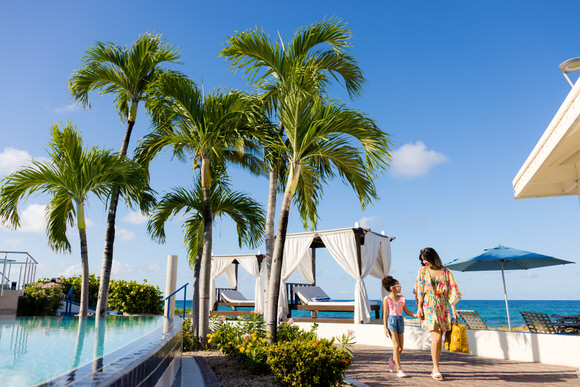 Woman and girl walking by pool
