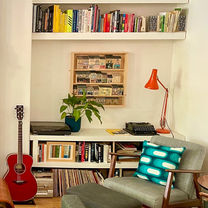 Retro 1970s green patterned cushion in a stylish room